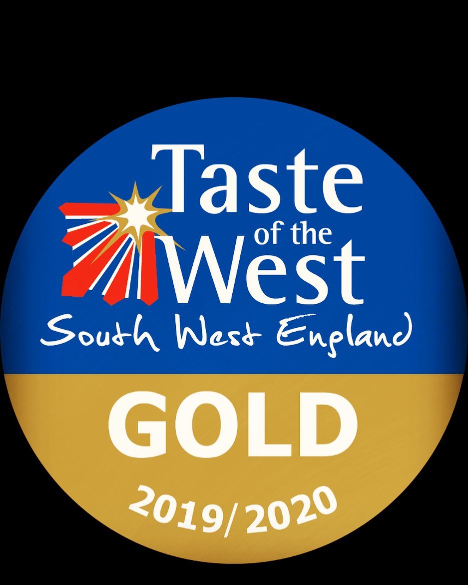 A round badge with a blue and gold design proudly displays GOLD Taste of the West South West England 2019/2020. A stylized star and regional map adorn the upper left.