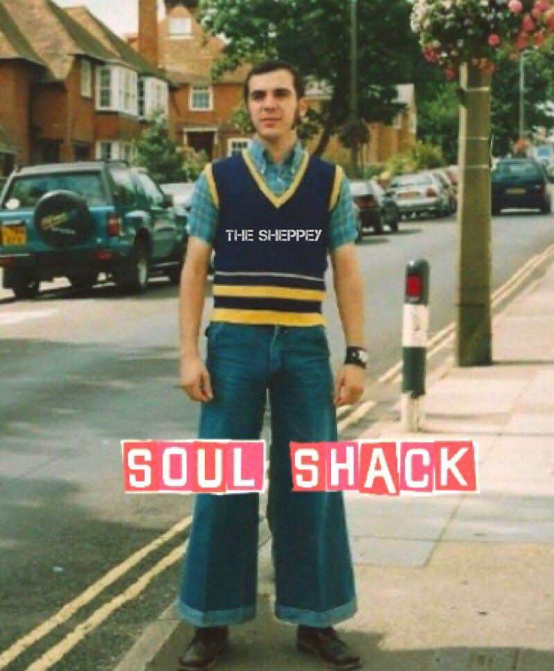 A young man stands on a suburban street wearing flared jeans, a blue checkered shirt, and a sleeveless sweater vest. The words THE SHEPPEY and SOUL SHACK are overlaid on the photo.