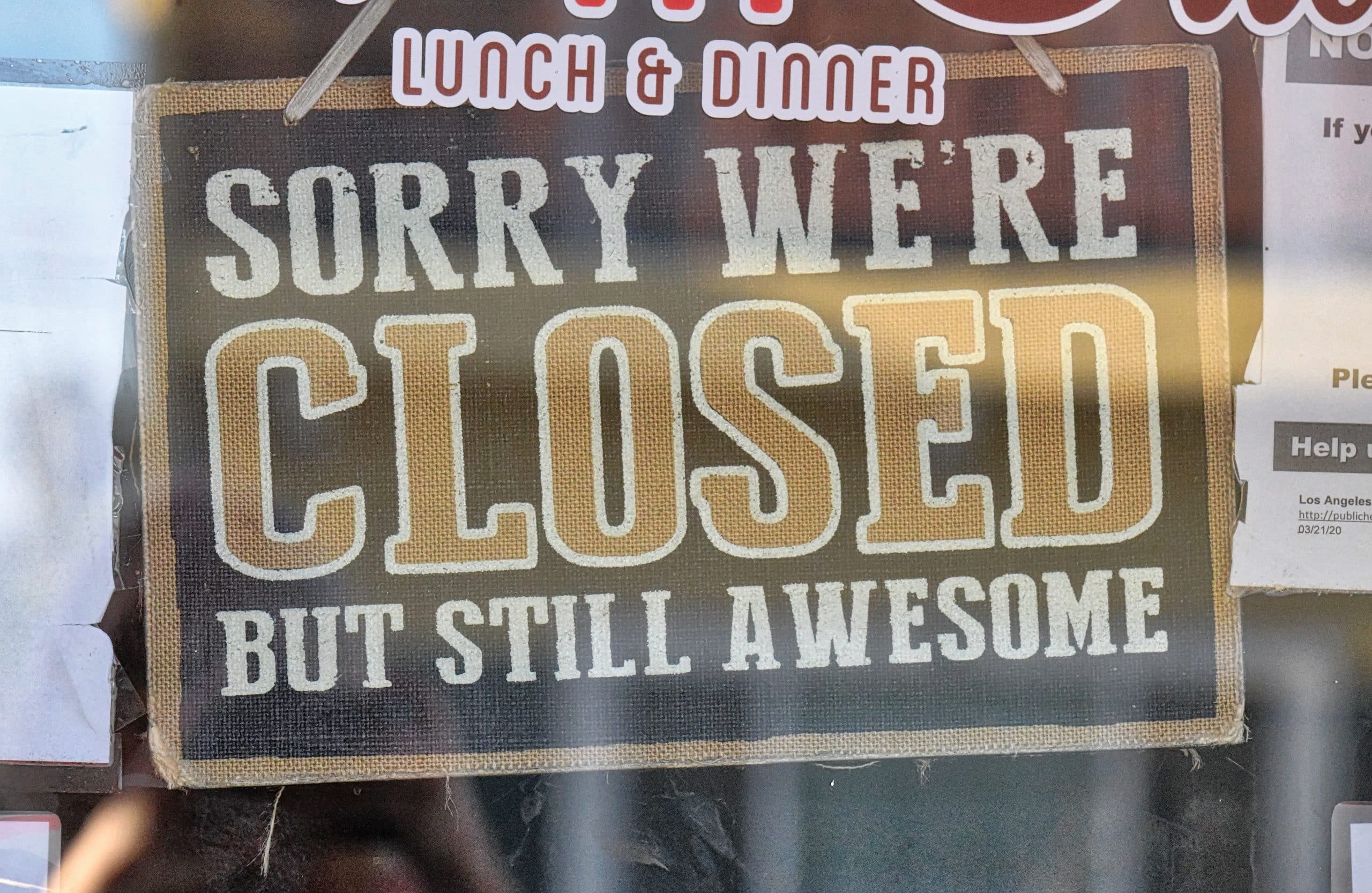 sign in a window saying that we are closed but still awesome